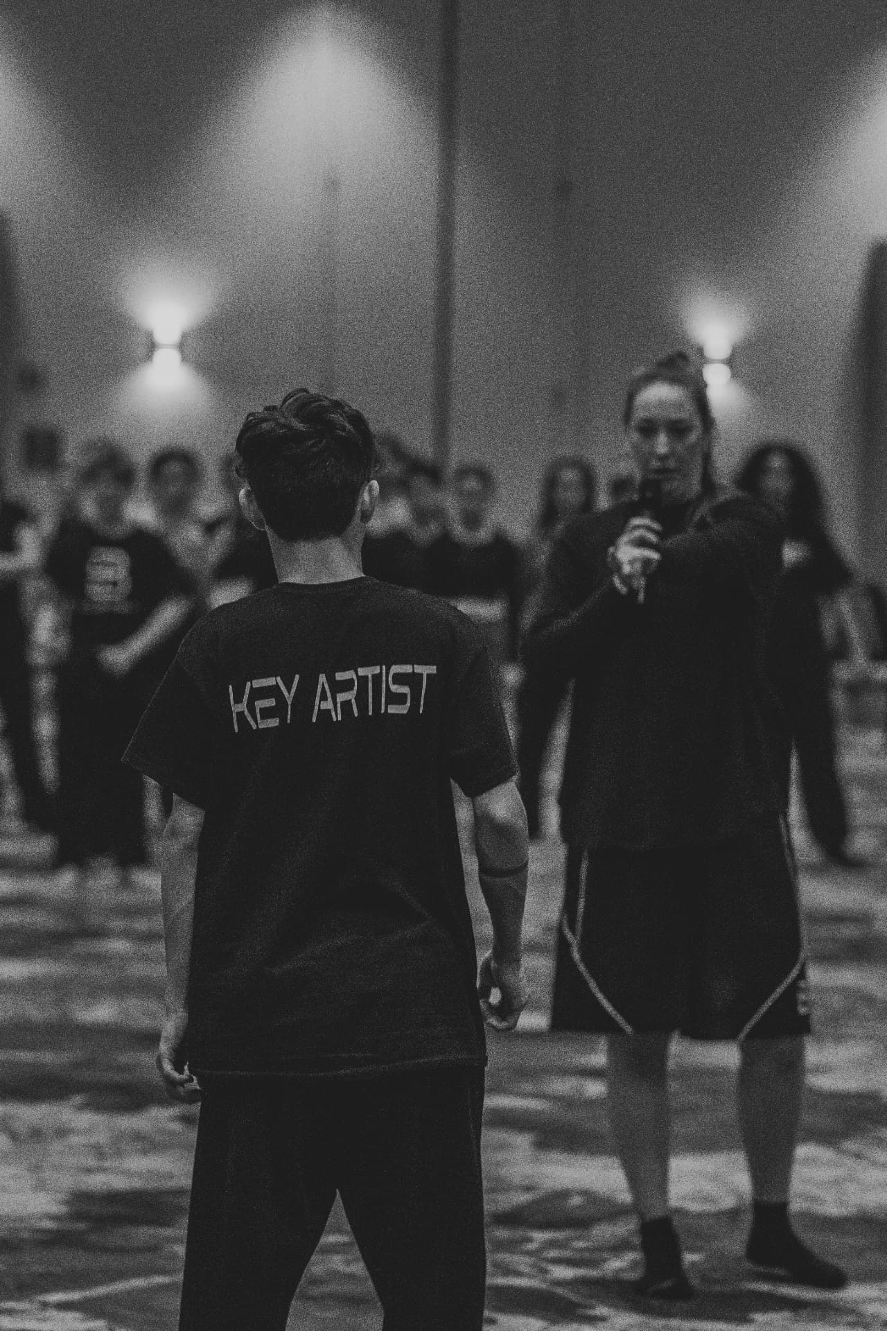 Key Artist assisting faculty on the floor